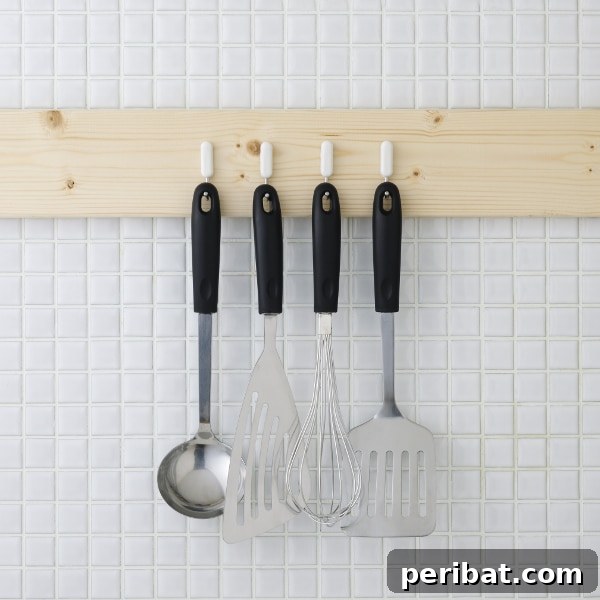 The Ultimate Command Strip Guide 75 Ingenious Uses and Application Tips 7 Kitchen utensils neatly hung on a wooden rack, a concept achievable with Command Hooks.