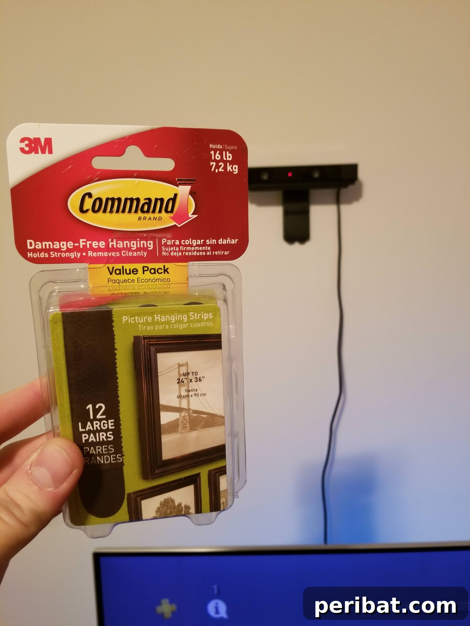 The Ultimate Command Strip Guide 75 Ingenious Uses and Application Tips 11 A hand holding Command Strips, demonstrating their small size and adhesive backing.