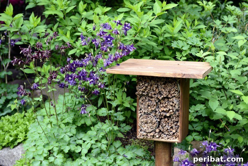 Simple bee hotel on a stand placed in the garden.