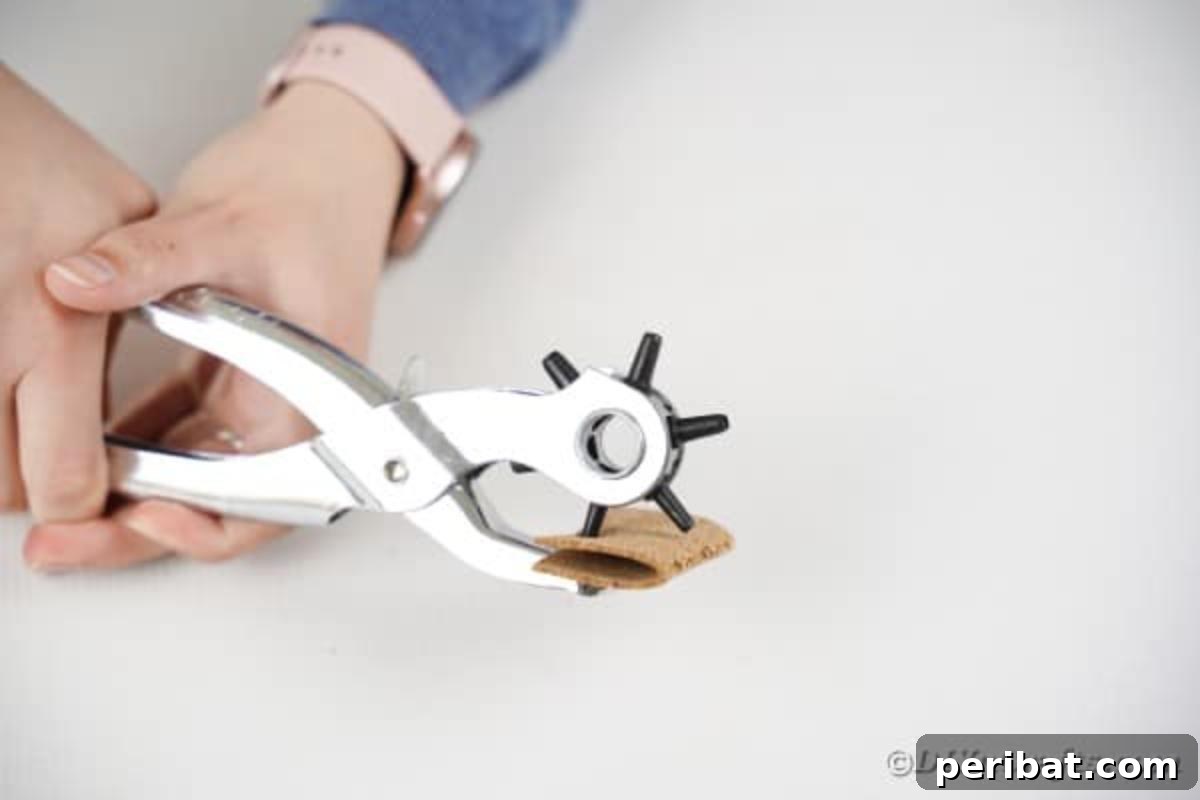 Leather hole punch held by woman