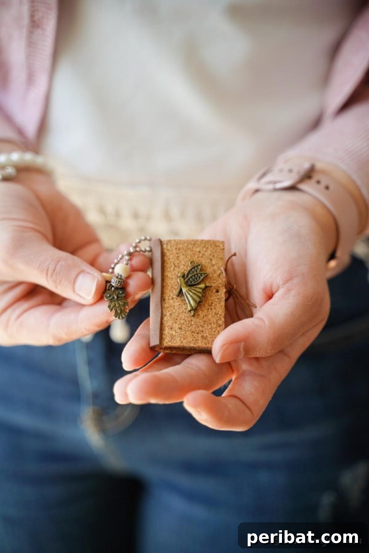 Woman holding book page keychain