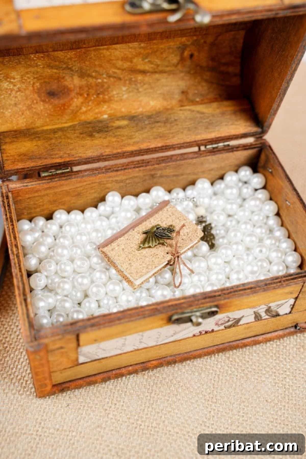 Miniature book inside a wooden chest with beads