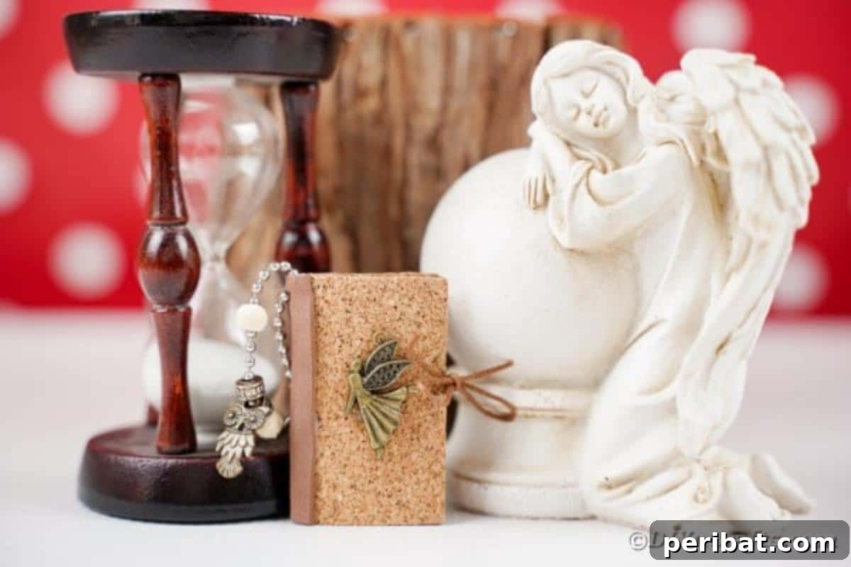 Mini book keychain laening against an hourglass