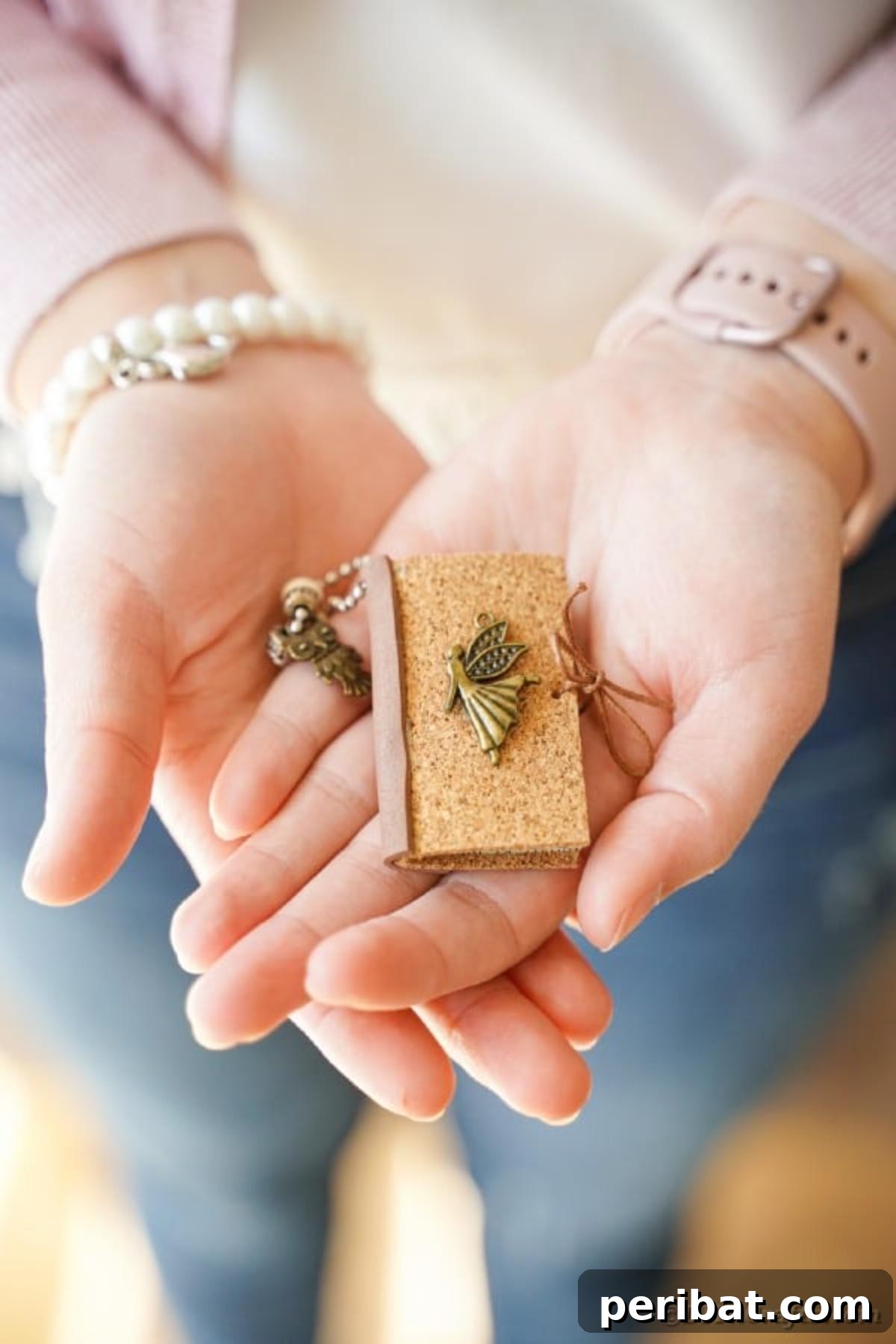 Woman holding book page keychain