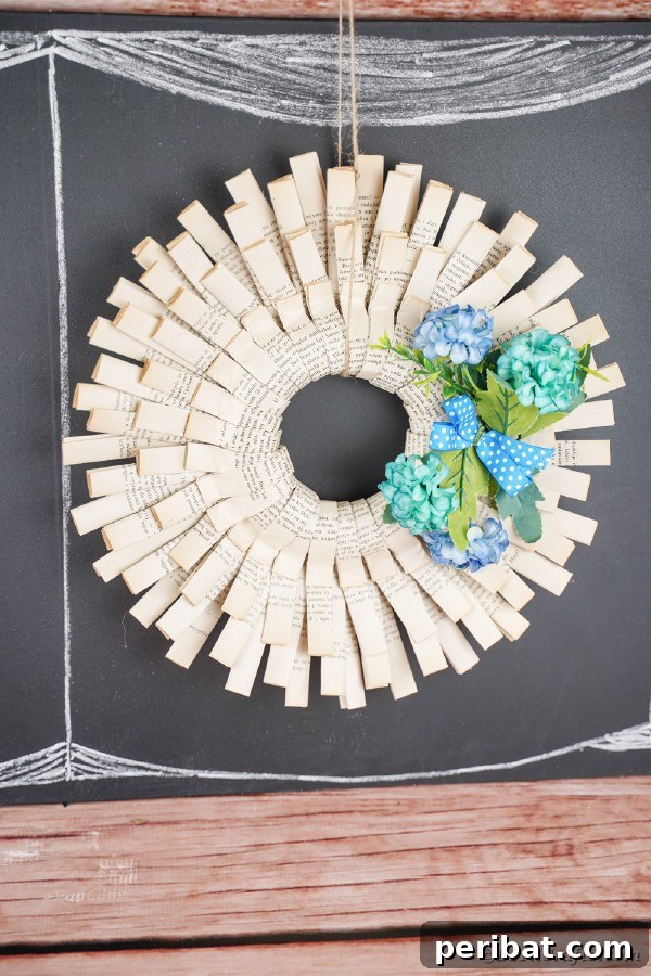 Simple and elegant folded paper wreath adorned with blue flowers