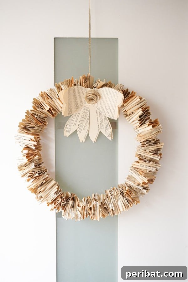 Rustic folded book page wreath on a white door