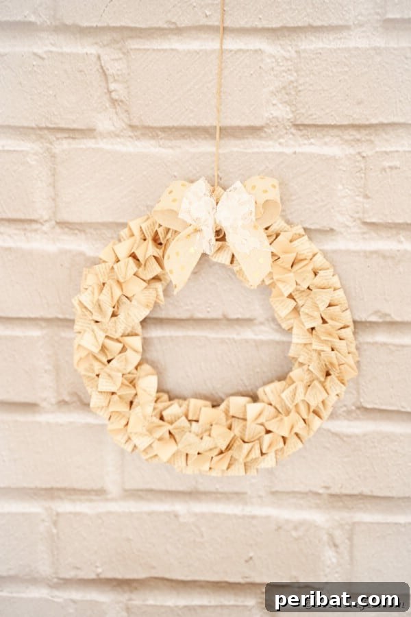 Elegant origami-style old book page wreath on a brick wall