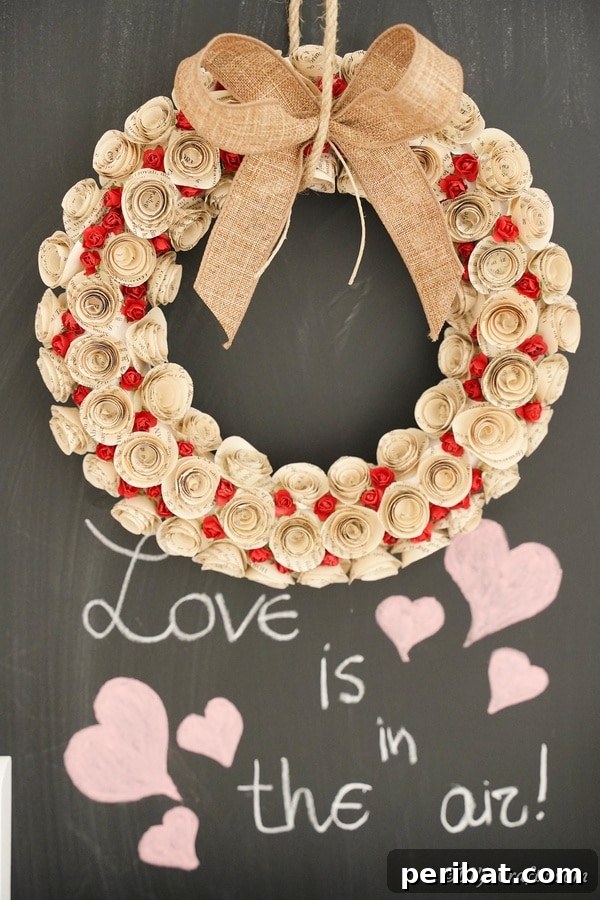 Beautiful rolled paper rose wreath made from old book pages, set against a chalkboard