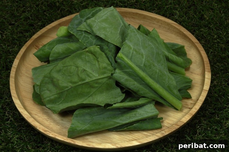 A close-up of wilted lettuce leaves being revived in a bowl of water with a splash of vinegar.