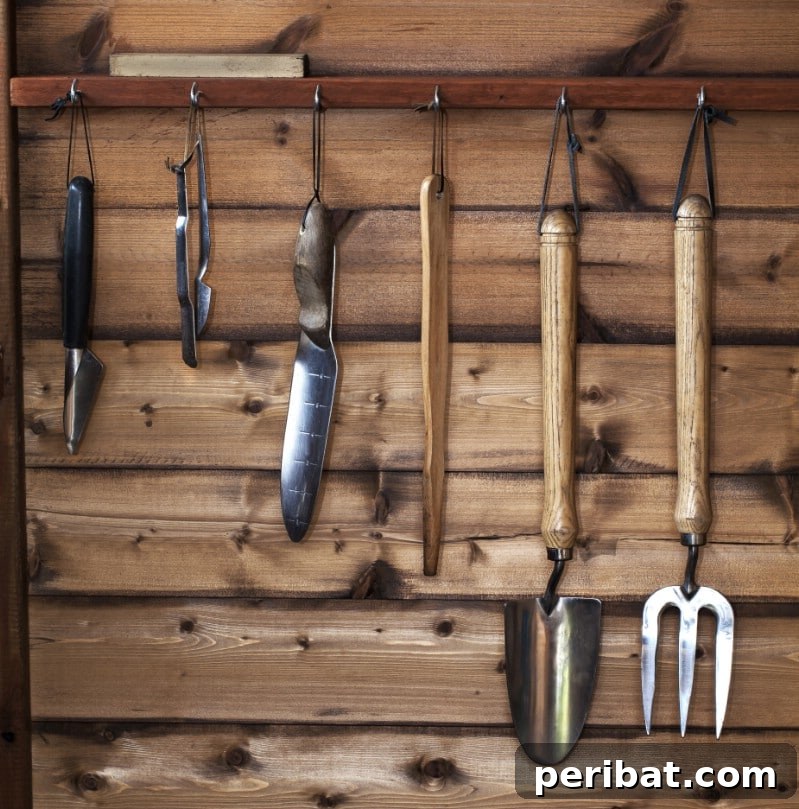 Cleaned and polished gardening tools, including a spade and trowel, neatly hung on a wall.
