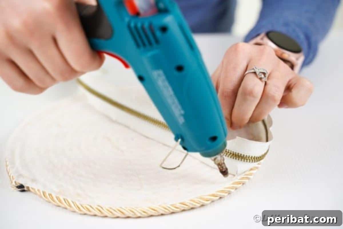 Effortless Chic DIY Rope Bag Tutorial 16 Gluing one side of the zipper onto the curved edge of a rope circle