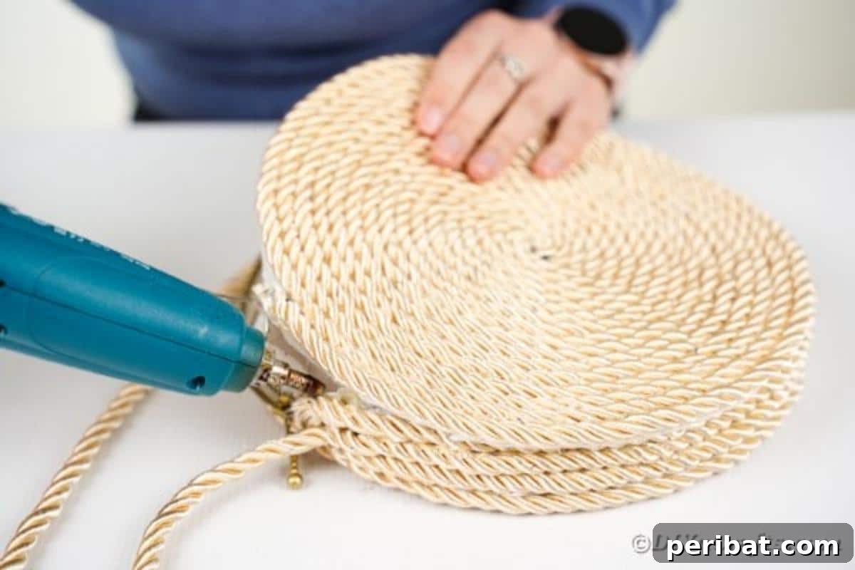 Effortless Chic DIY Rope Bag Tutorial 18 Gluing the second rope circle onto the top of the purse's side wall