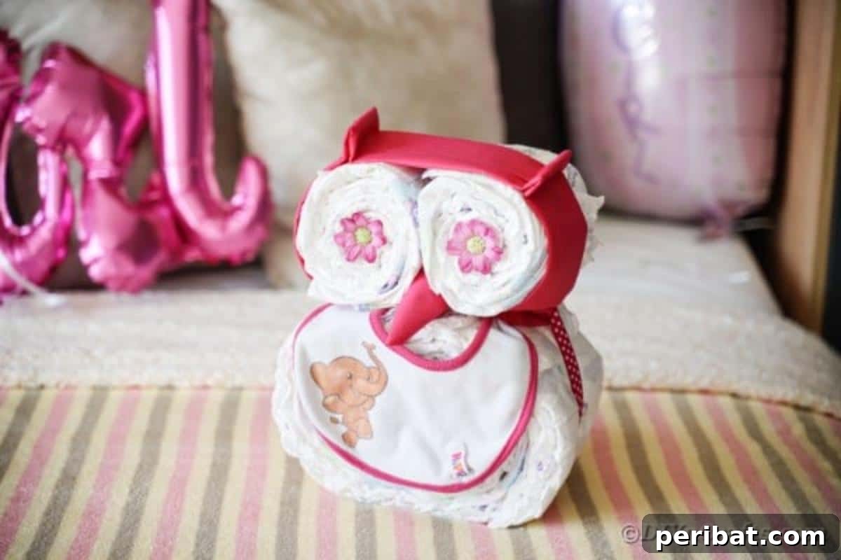 Owl diaper cake laying on striped bedding