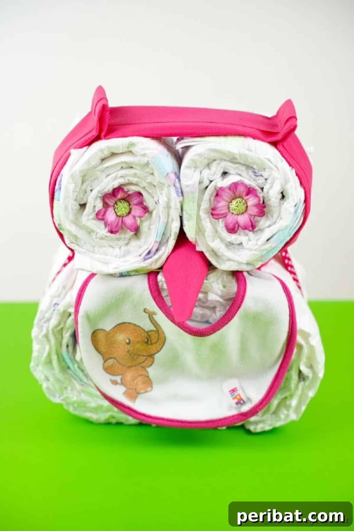 Owl diaper cake on green table