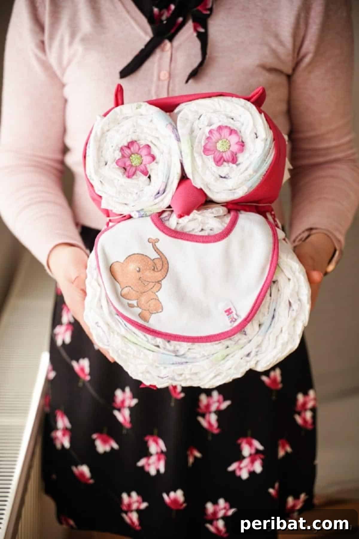 Woman holding owl diaper cake