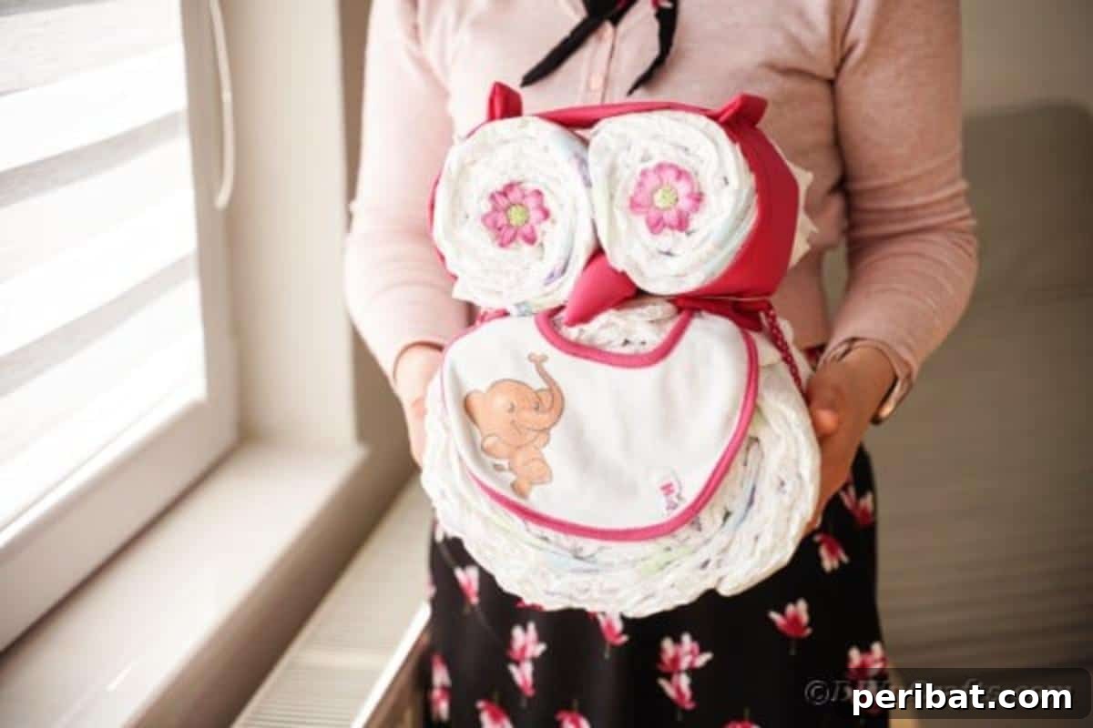 Woman holding diaper cake owl