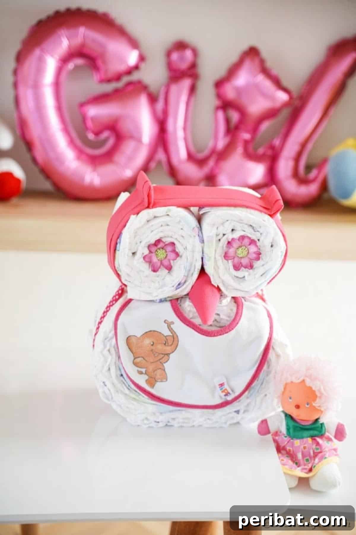 Owl diaper cake on table with base