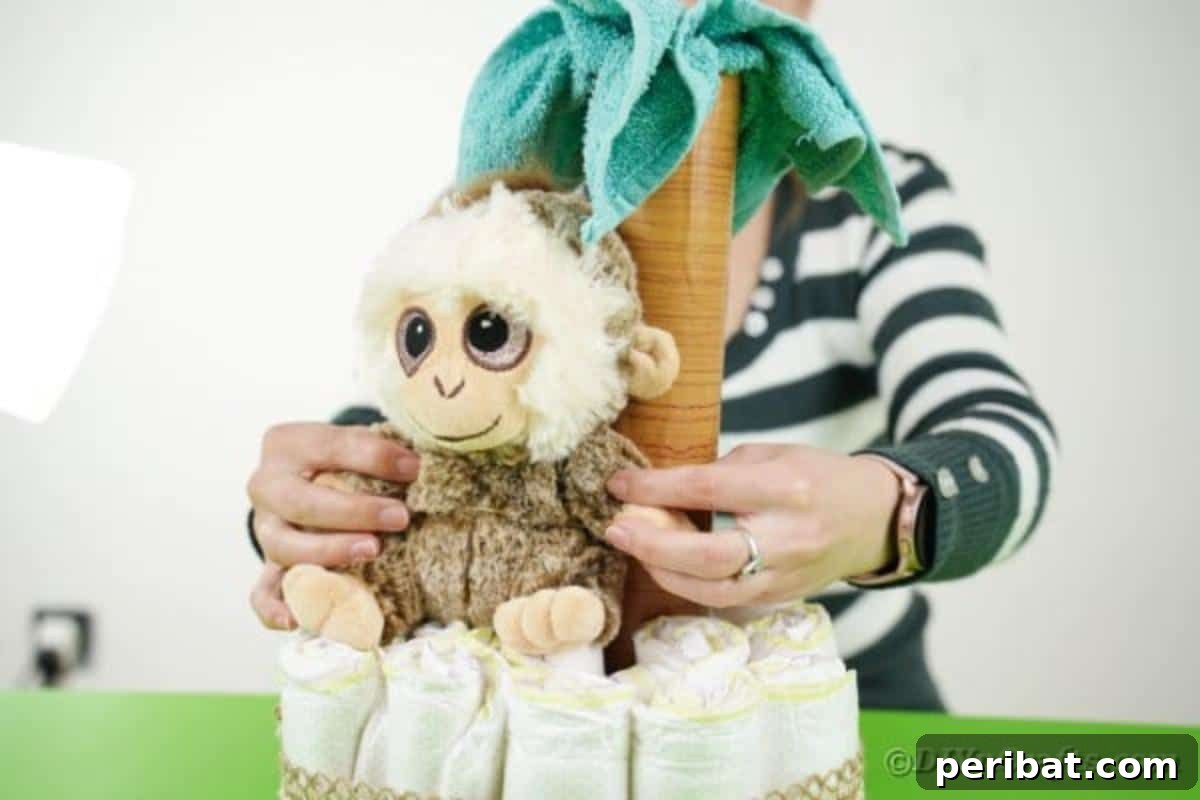 Sweet Safari Palm Diaper Cake 13 Adding monkey to diaper cake