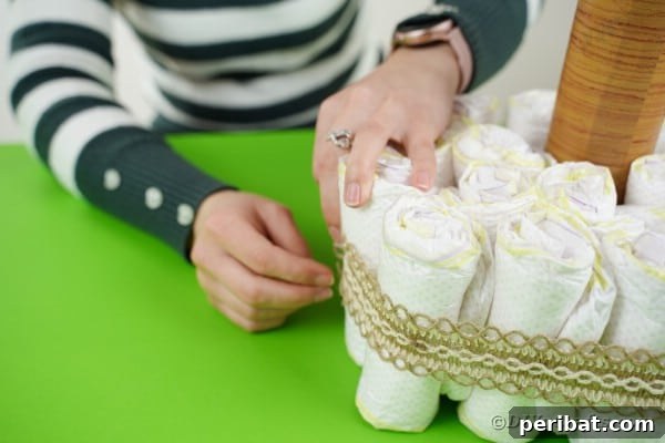 Sweet Safari Palm Diaper Cake 17 Wrapping diapers with burlap lace