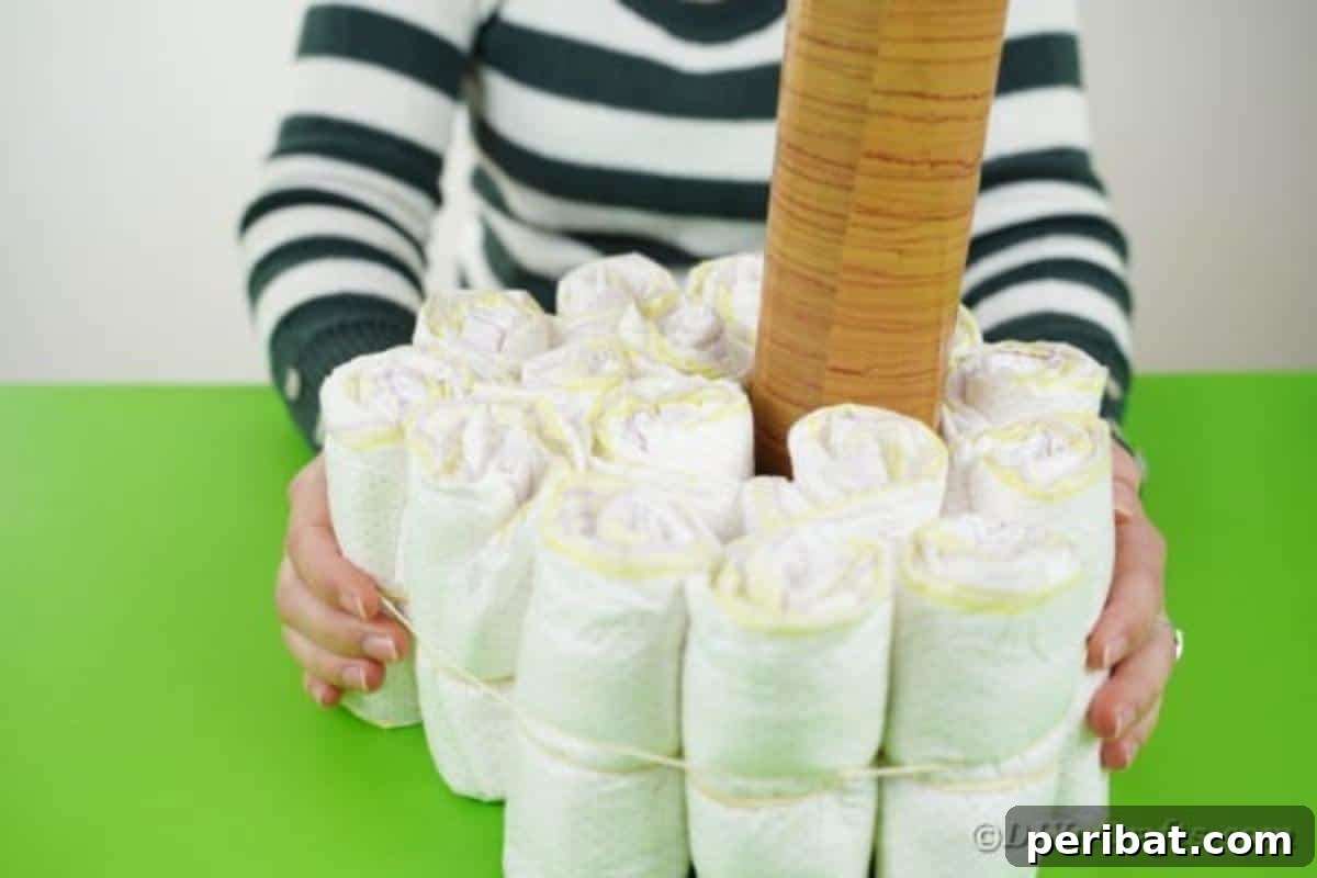 Sweet Safari Palm Diaper Cake 10 Adding rubber band around diapers