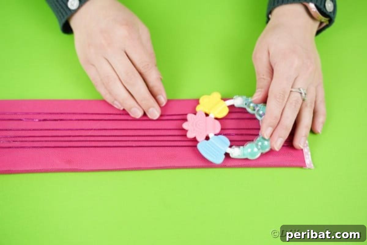 A baby rattle securely attached to the top end of the guitar neck, serving as a charming detail