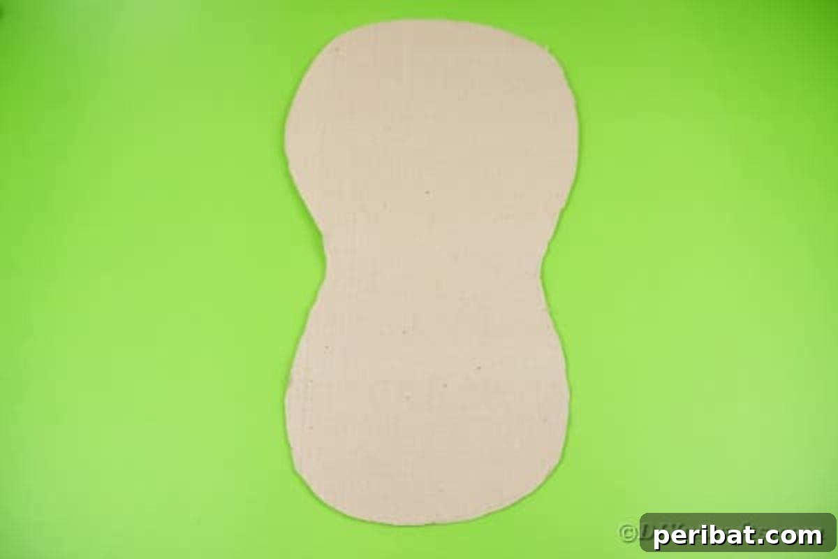 A guitar body shape clearly traced and cut from a large piece of cardboard, serving as the base