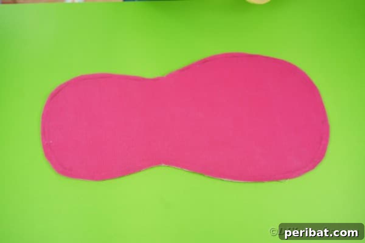 The cardboard guitar body neatly covered with tissue paper, creating a smooth surface