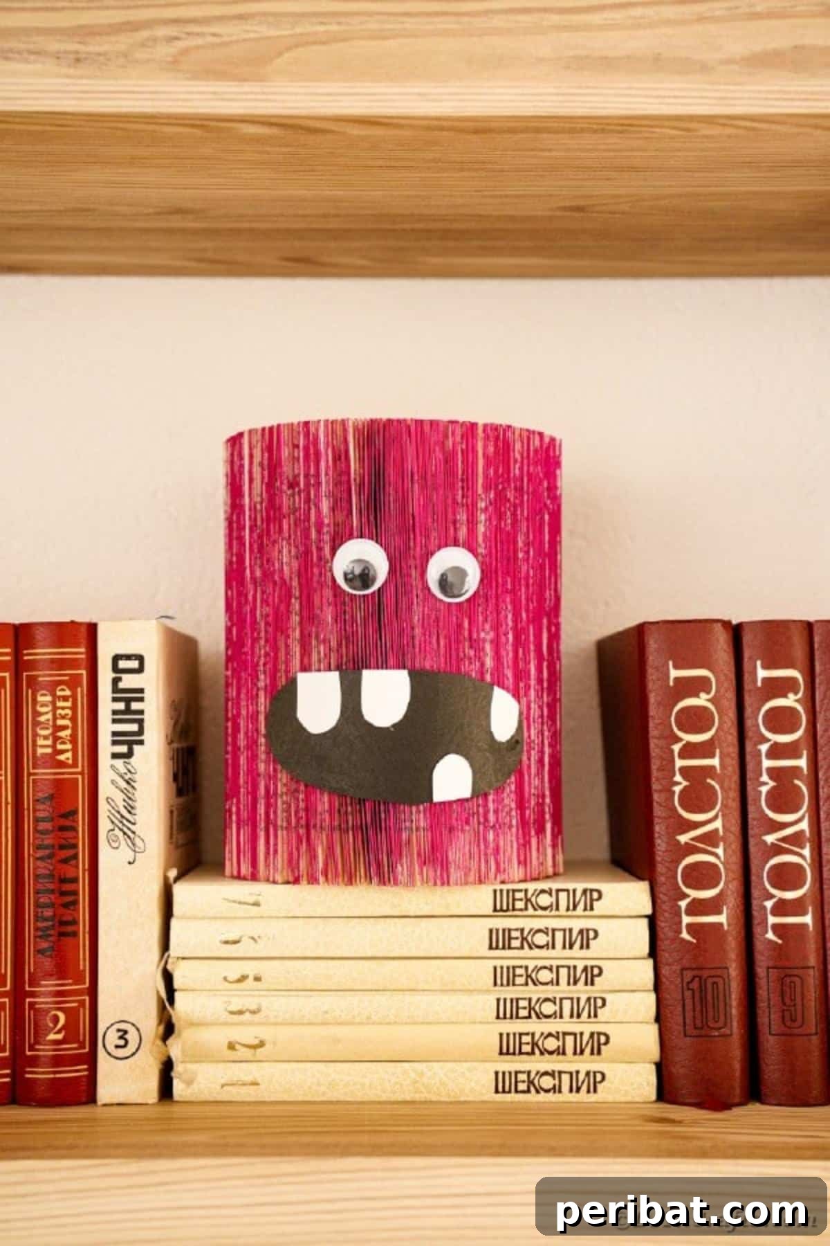 Old book pink monster craft on stack of books