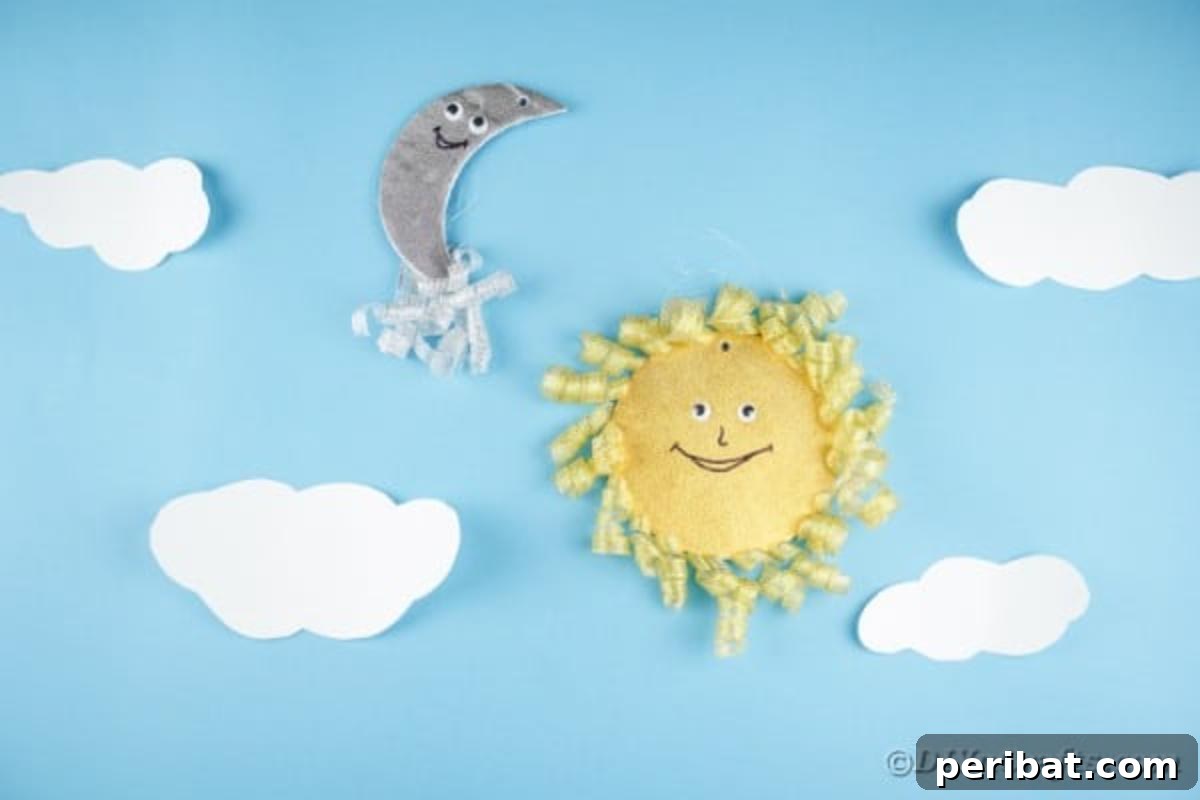 Sparkling CD Moon & Sun Nursery Mobile 7 Sun and moon decoration on blue wall with clouds