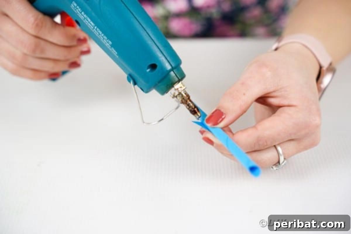 Gluing the end of paper onto a dowel