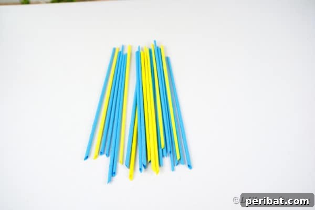 Stack of finished paper-covered dowels, ready for trimming