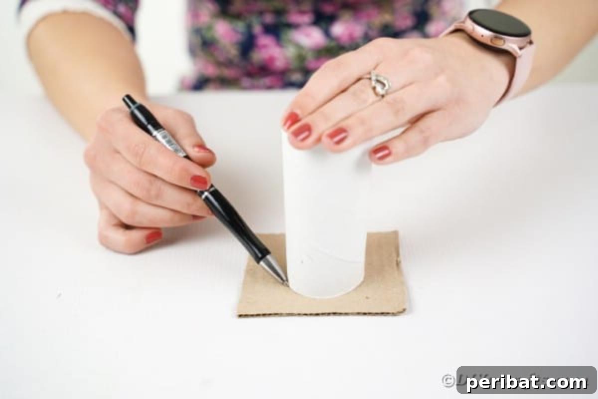 Tracing a circle on cardboard using a toilet paper roll
