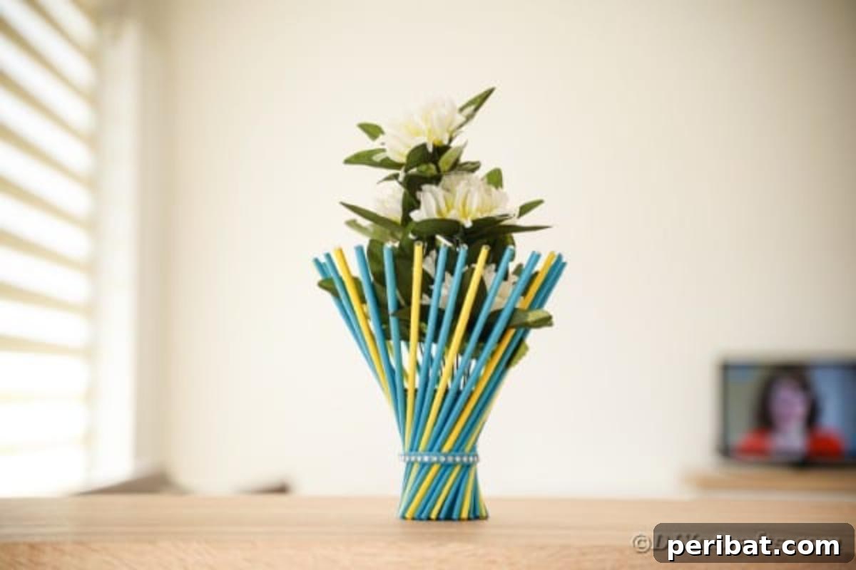 Colorful stick vase on wood table, showcasing twisted paper straws