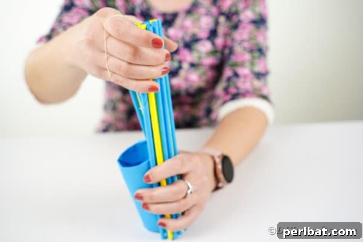 Attaching paper straws to the base of the vase