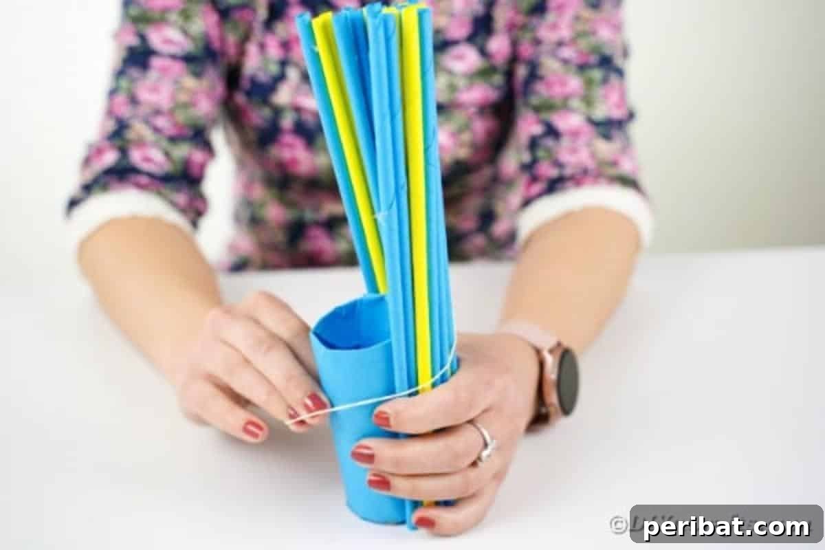 Securing partially attached paper straws with a rubber band