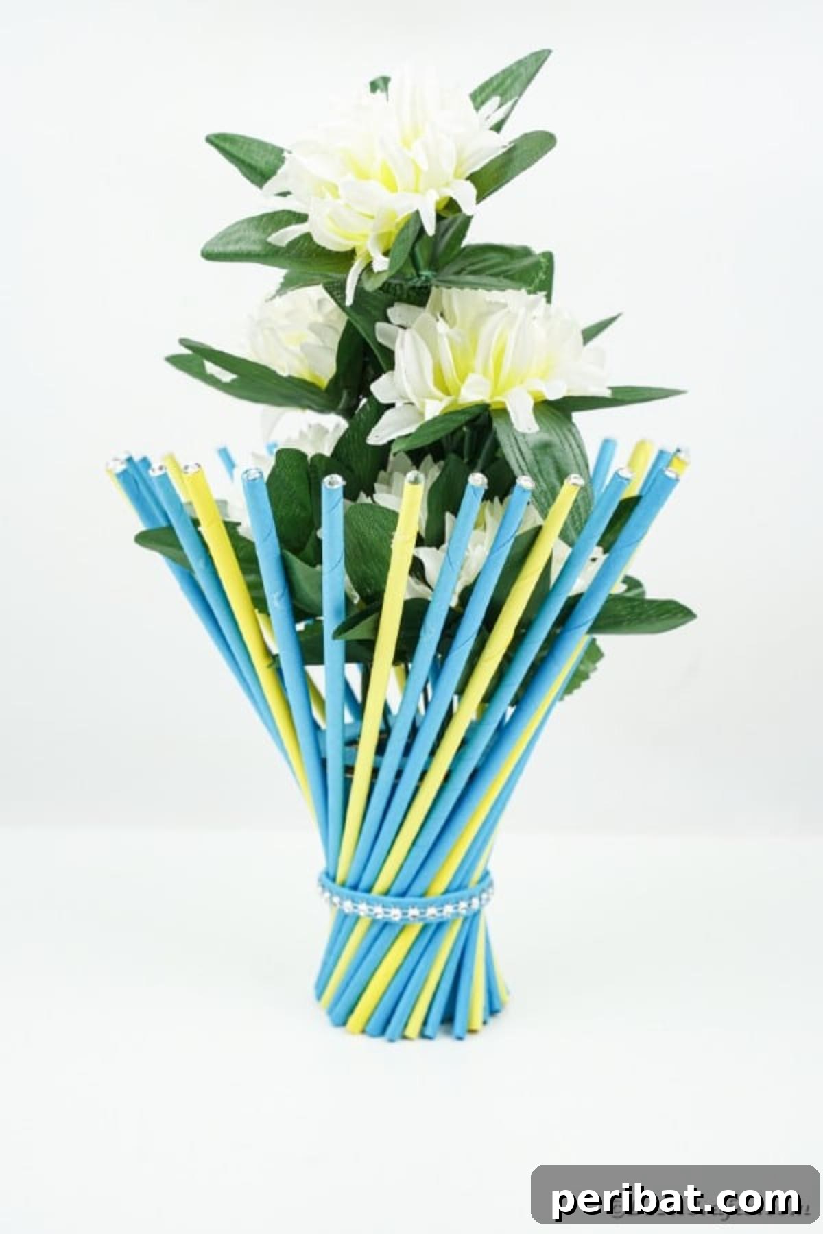 Blue and yellow twisted vase displayed on a white counter
