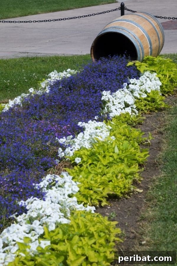 Cascading Flower Pot Art for Stunning Garden Decor 19 Purple and white flowers spilling out of a whiskey barrel, creating a delicate, colored walking trail effect in a garden setting.