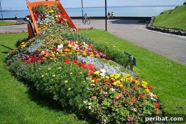 Cascading Flower Pot Art for Stunning Garden Decor 25 An old wheelbarrow repurposed as a charming garden planter, overflowing with a vibrant rainbow of flowers, creating the illusion of a spilled cascade.