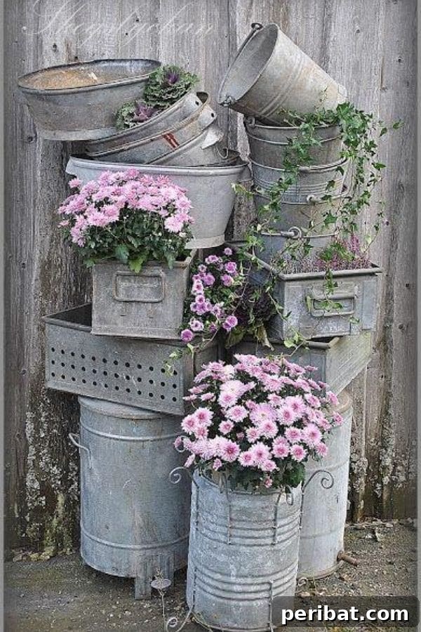 32 DIY Vintage Garden Crafts to Add Rustic Charm 16 A creative arrangement of stacked galvanized buckets and barrels, designed as a vintage garden display with minimal floral accents.