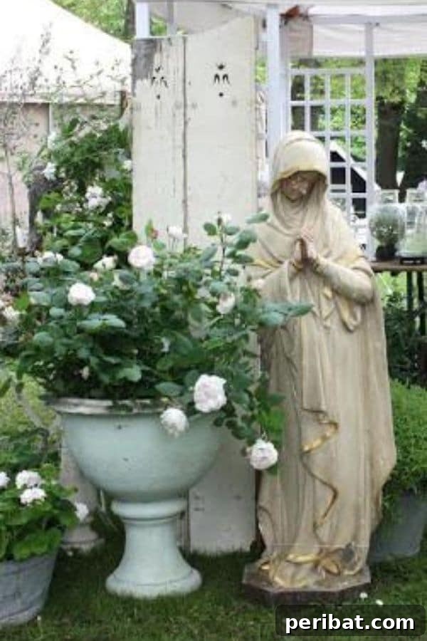 32 DIY Vintage Garden Crafts to Add Rustic Charm 22 An aged concrete statue positioned gracefully in a garden, complemented by rustic planters, suggesting a timeless aesthetic.