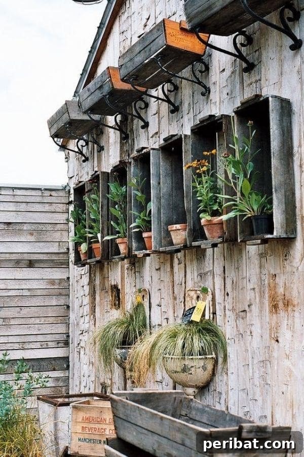 32 DIY Vintage Garden Crafts to Add Rustic Charm 28 A collection of vintage wooden and galvanized boxes acting as wall-mounted planters on the side of a house.