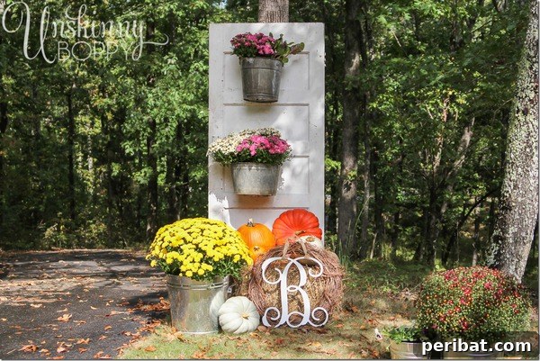 Old door plant stand decorated with fall flowers and pumpkins