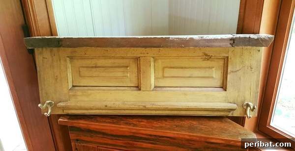 Primitive wood shelf with hooks, made from an upcycled door section