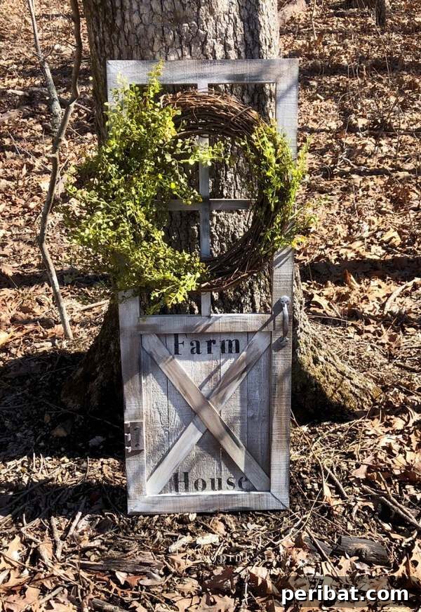 Old door wreath stand in a farmhouse barn door style