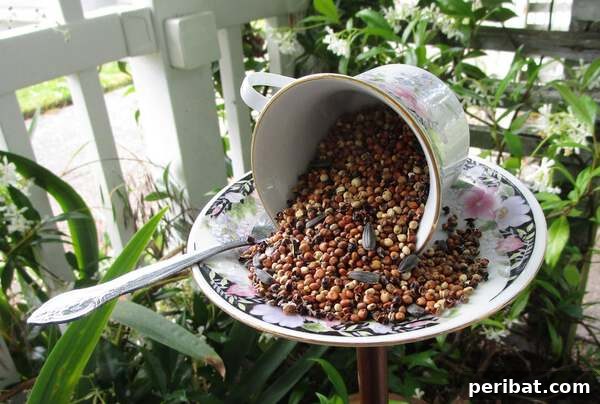 A delicate teacup and saucer repurposed into a charming bird feeder, hanging in a garden