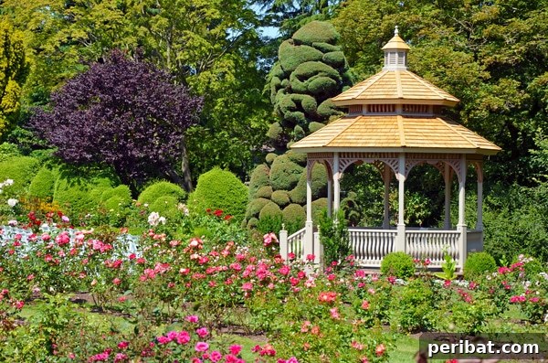 A classic white gazebo nestled within a vibrant garden, surrounded by an abundance of colorful flowers and lush greenery