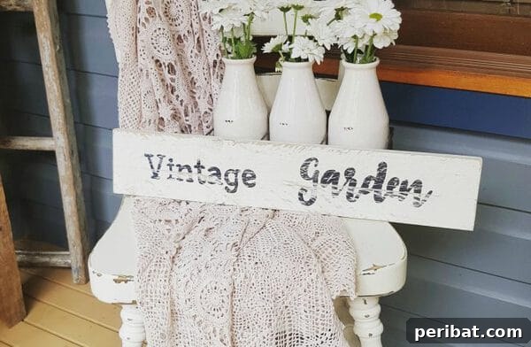 White vintage garden sign made from wooden slats