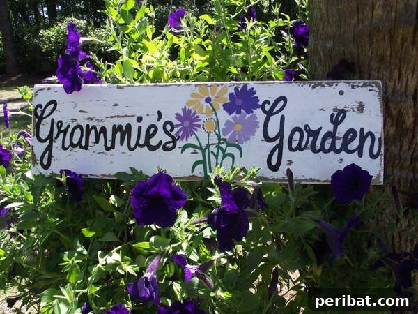 Weathered wooden sign reading 'Grammie's Garden' with flower accents