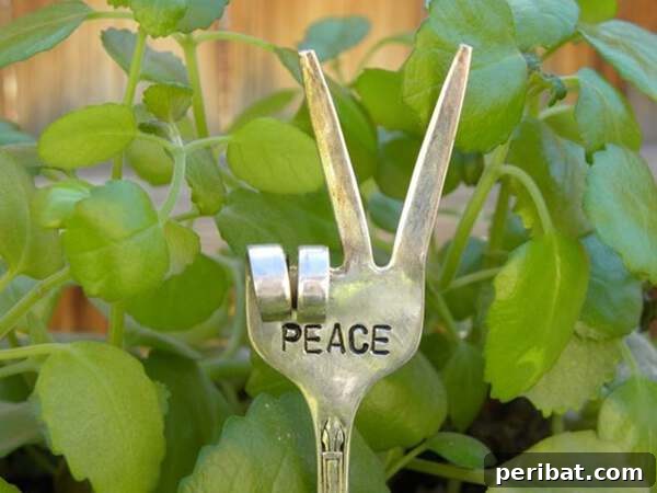 Metal fork bent into a peace sign, serving as garden decor