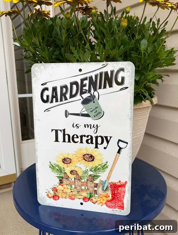 Metal sign reading 'Gardening is My Therapy' with floral designs